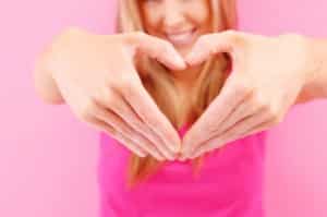 Woman with her hands in a heart shape