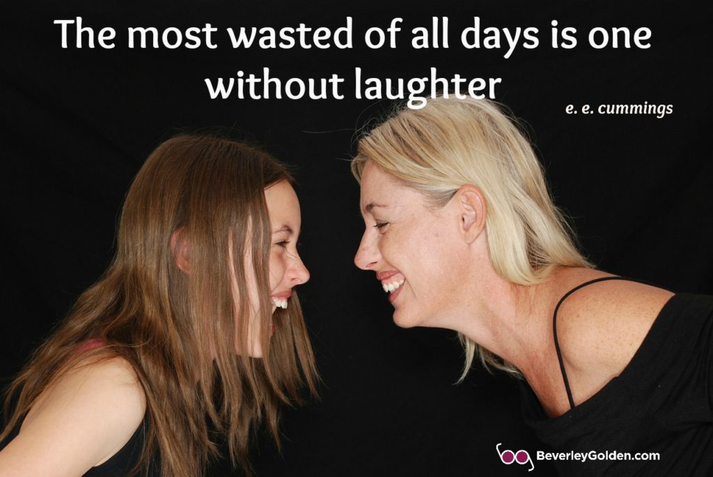 Two women facing each other laughing