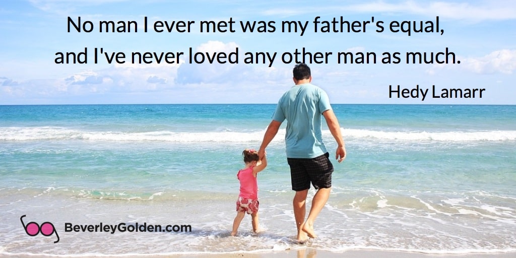 Father and child at the beach holding hands_father love