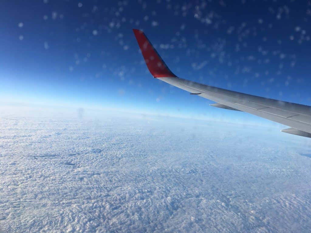 View of a sea of clouds from an airplane window