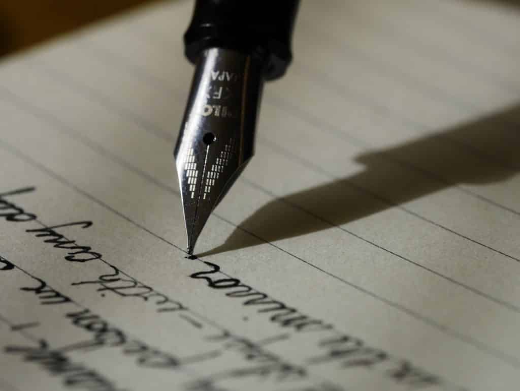 Writing with a pen on paper